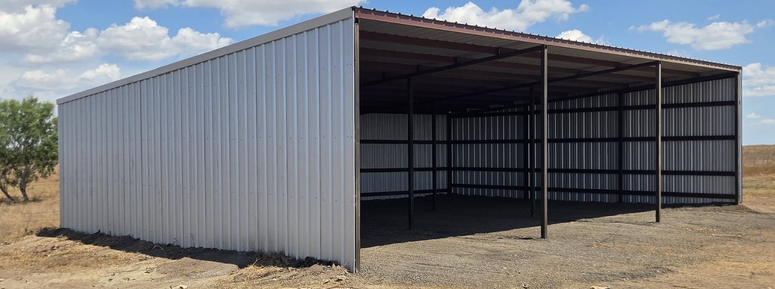 Large open-sided metal equipment barn with grey steel cladding, built by Dawn Till Dusk Construction